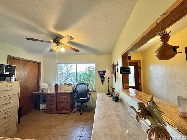 office area with ceiling fan, light tile patterned floors, and a textured ceiling