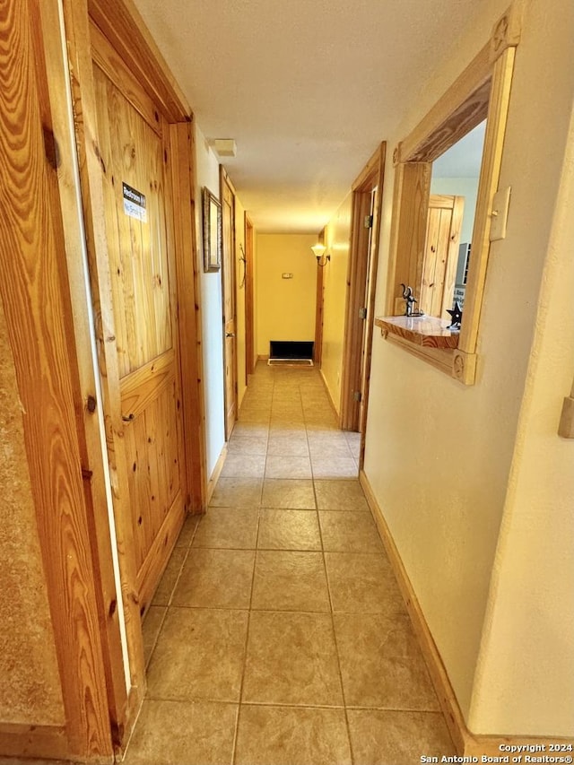 hall with light tile patterned floors