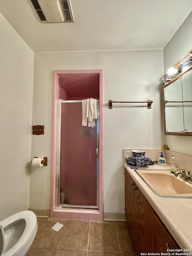 bathroom with vanity, tile patterned floors, and a shower with shower door