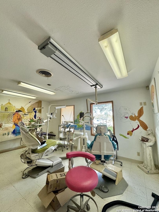 gym with a textured ceiling