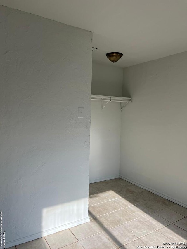 spacious closet featuring light tile patterned floors