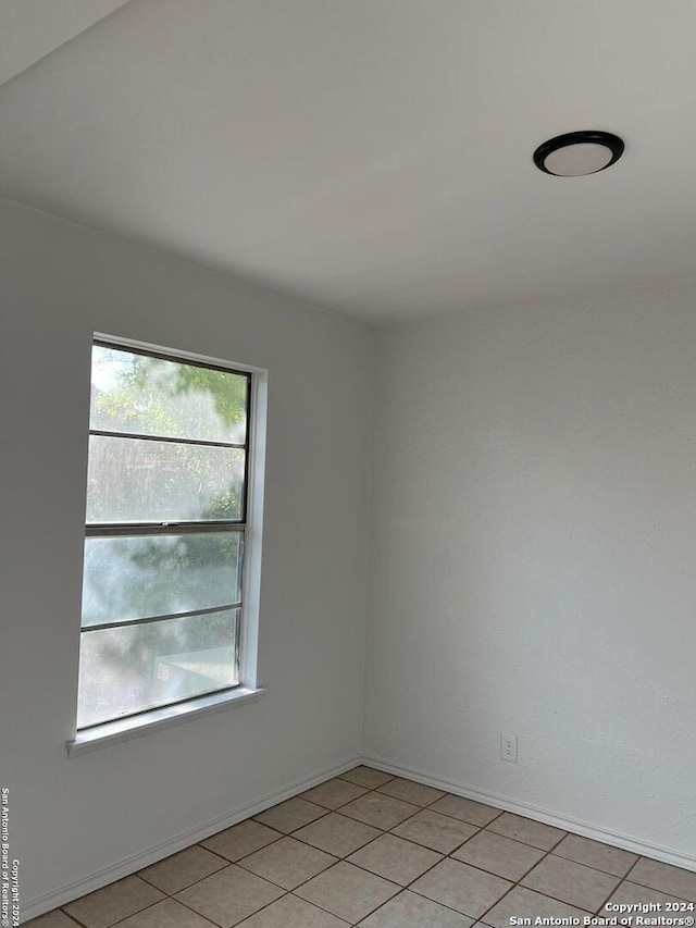 empty room with light tile patterned floors