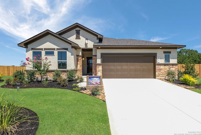 view of front of house featuring a garage and a front lawn