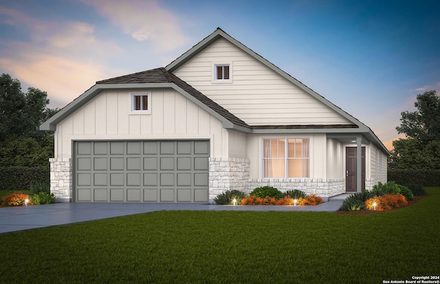 view of front of property featuring a garage and a lawn