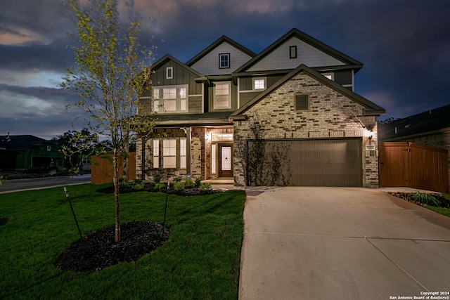 view of front of property featuring a lawn and a garage