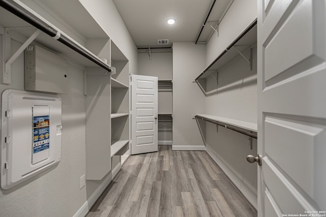 spacious closet featuring light hardwood / wood-style floors