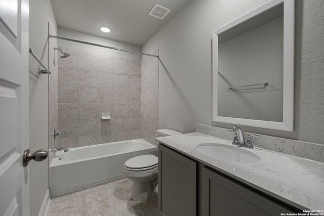 full bathroom with tiled shower / bath, vanity, toilet, and tile patterned flooring