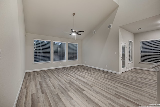 spare room with high vaulted ceiling, light wood-type flooring, and ceiling fan