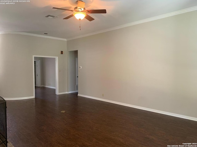 empty room featuring dark hardwood / wood-style flooring, crown molding, and ceiling fan