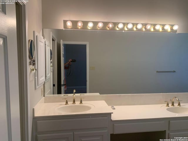 full bathroom featuring a sink and double vanity