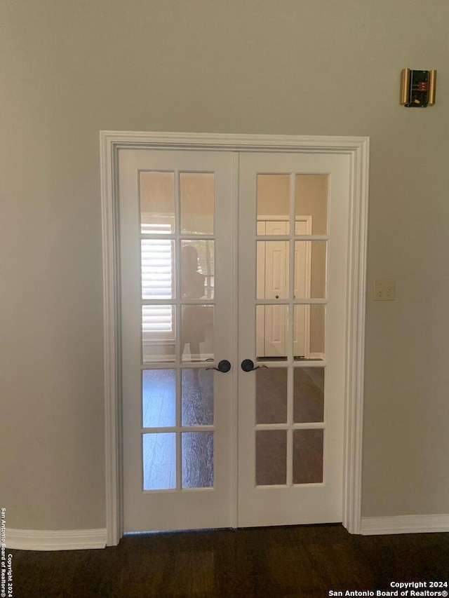 entryway featuring baseboards and french doors