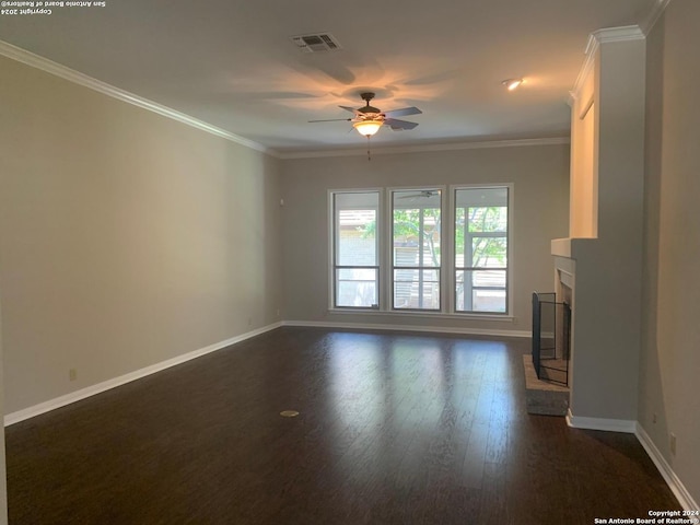 unfurnished living room with a fireplace with raised hearth, baseboards, visible vents, and crown molding