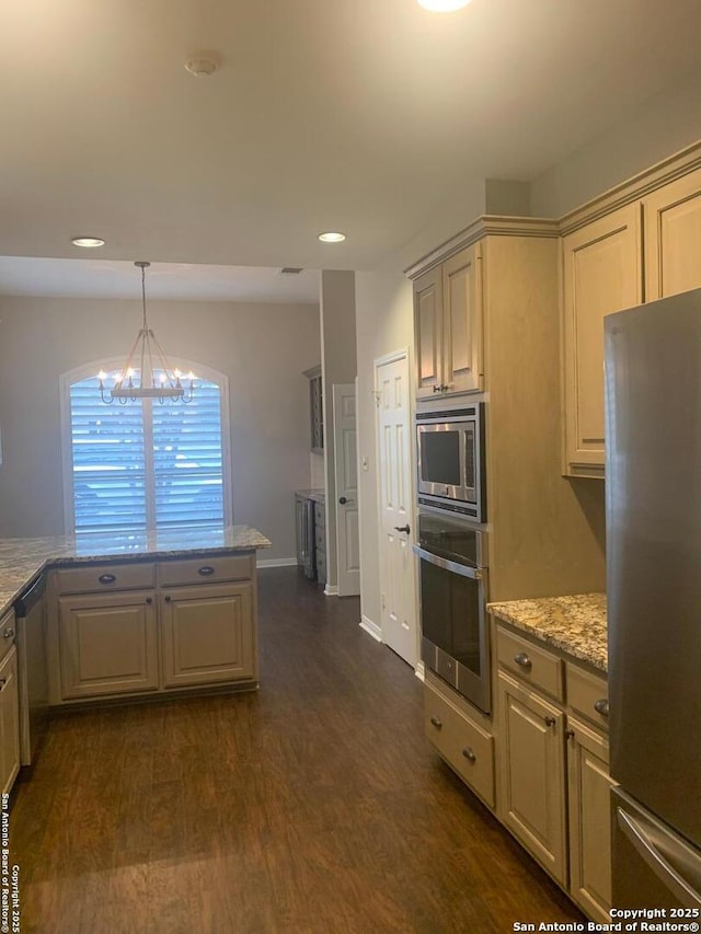 kitchen with stainless steel appliances, dark wood-type flooring, light stone countertops, an inviting chandelier, and pendant lighting