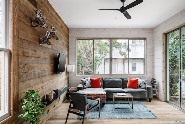 sunroom featuring ceiling fan