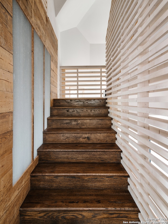 stairs with vaulted ceiling