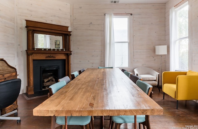 dining room with a healthy amount of sunlight and dark hardwood / wood-style flooring