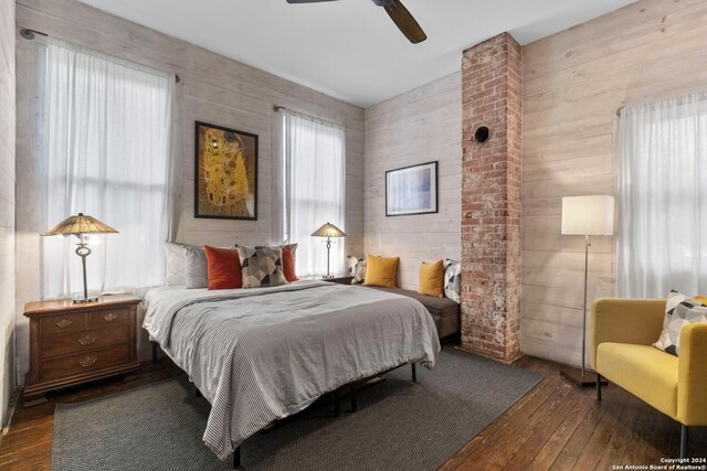 215 Beauregard, San Antonio, TX 78204 - bedroom with wood walls, ceiling fan, and dark wood finished floors