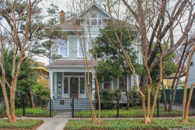 215 Beauregard, San Antonio, TX 78204 - victorian home with a fenced front yard, a shingled roof, a chimney, and a gate