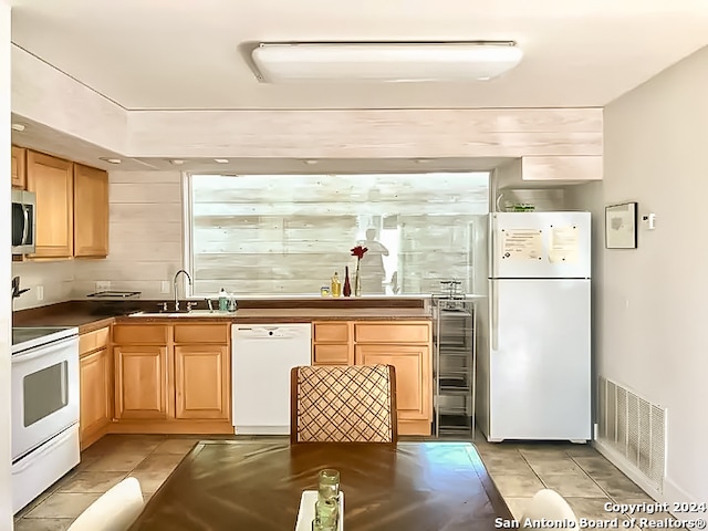 kitchen featuring sink and white appliances