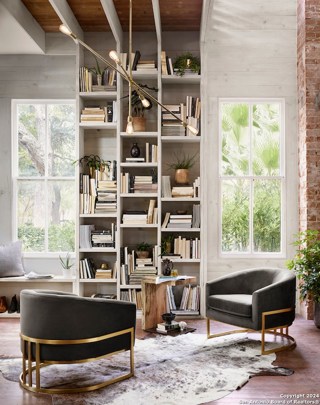 sitting room with brick wall, wood ceiling, and a healthy amount of sunlight