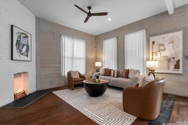 215 Beauregard, San Antonio, TX 78204 - living area featuring wooden walls, a ceiling fan, wood finished floors, and a brick fireplace