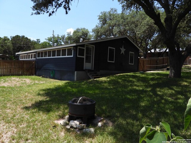 back of house featuring a yard