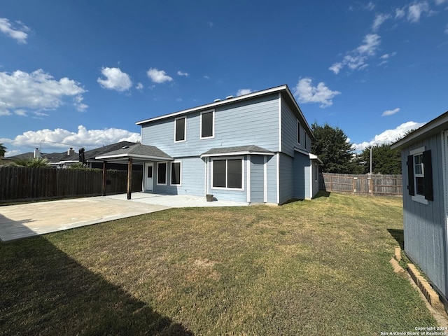 rear view of house featuring a fenced backyard, a lawn, and a patio