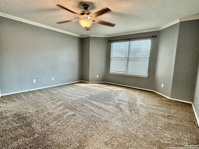 spare room with a textured ceiling, carpet, ornamental molding, and ceiling fan