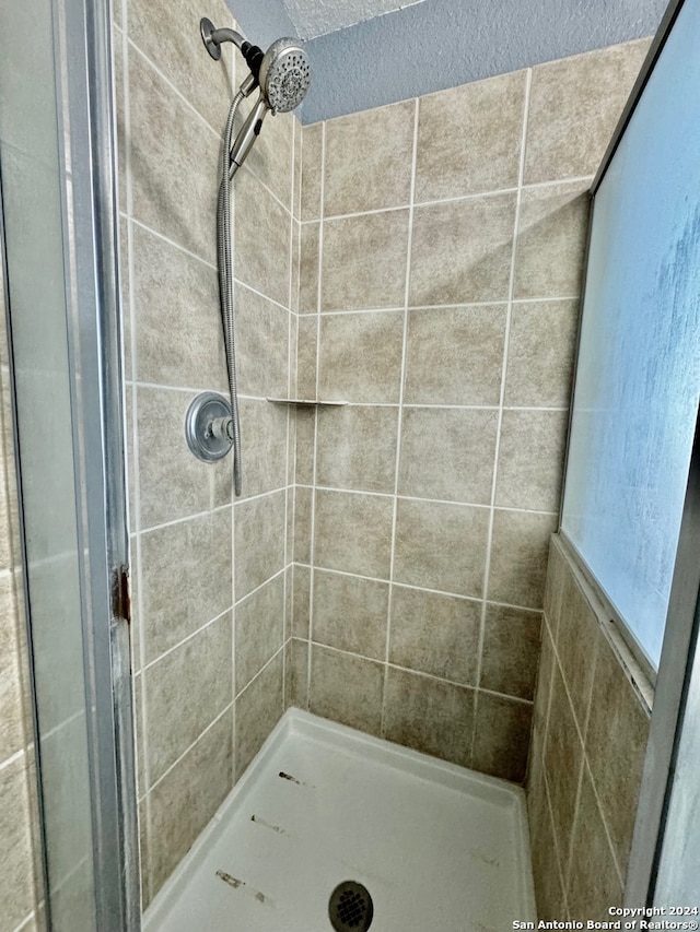 bathroom with tiled shower