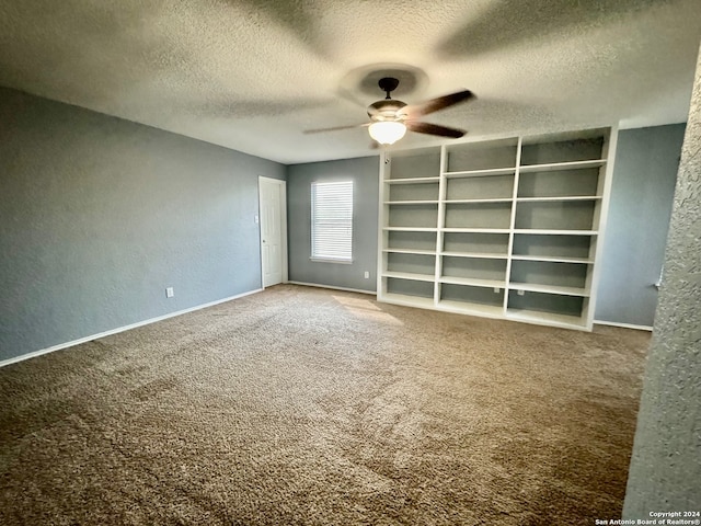 spare room with ceiling fan, a textured ceiling, and carpet