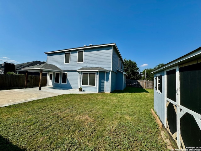 rear view of house with a yard