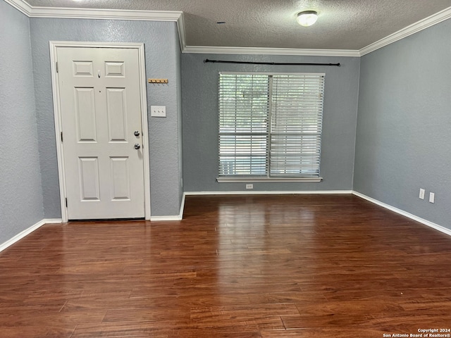 entryway with hardwood / wood-style flooring, a textured ceiling, and ornamental molding