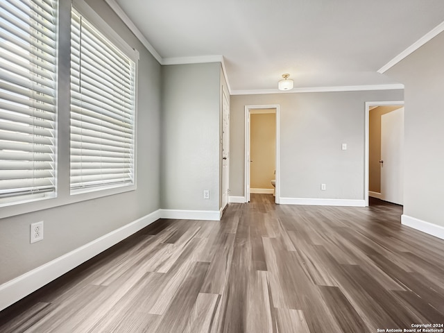 spare room featuring ornamental molding and hardwood / wood-style floors