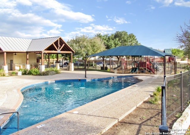 view of pool featuring a playground and a gazebo