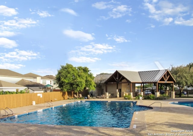 view of swimming pool with a patio