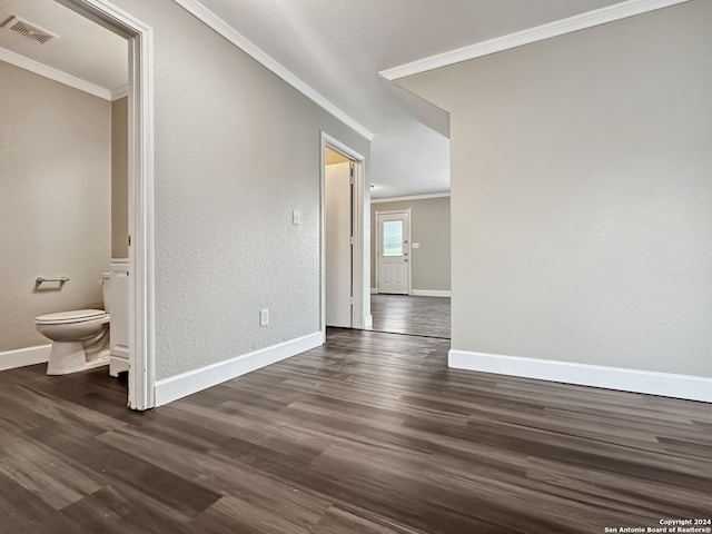 spare room with dark wood-type flooring and ornamental molding