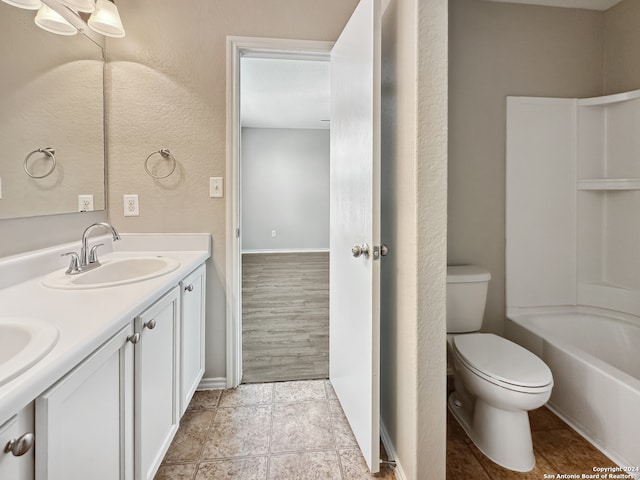 full bathroom with bathtub / shower combination, double sink vanity, toilet, and hardwood / wood-style flooring