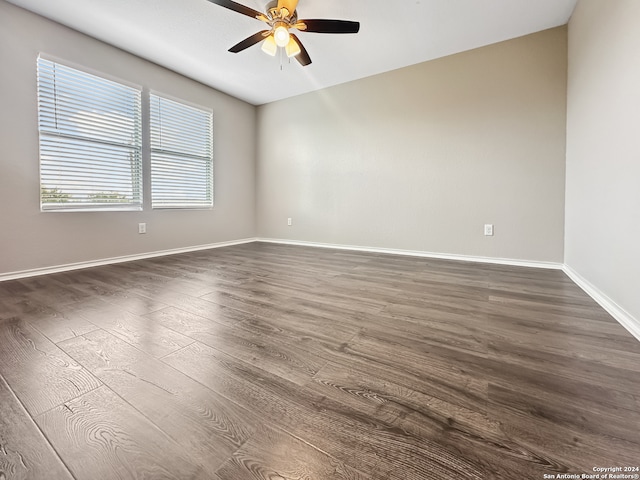 empty room with ceiling fan and hardwood / wood-style flooring