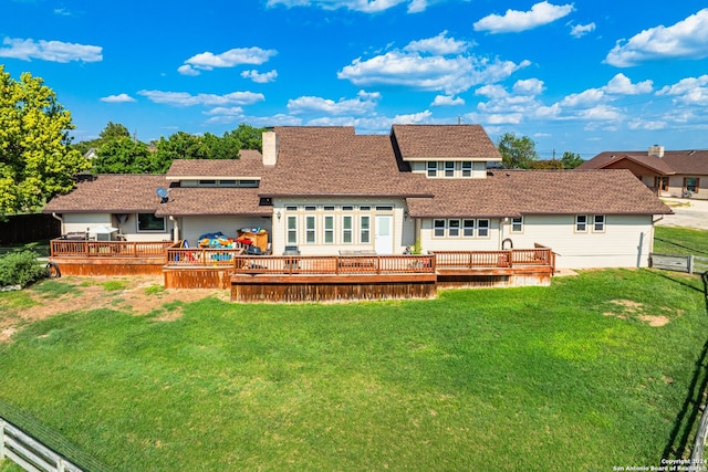 back of house with a wooden deck and a yard