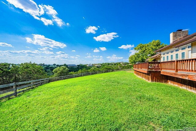 view of yard with a deck and a rural view