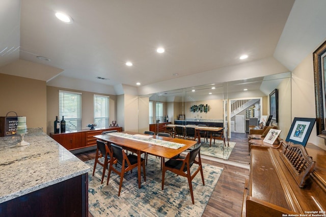 dining room featuring lofted ceiling and dark hardwood / wood-style floors