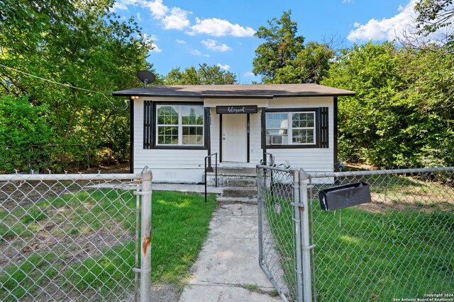 bungalow-style house with a front yard