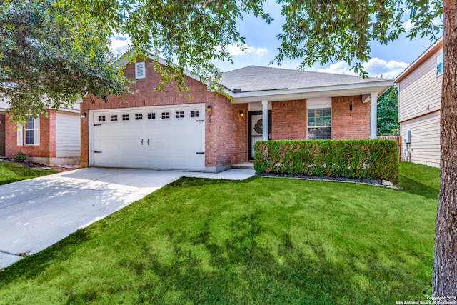 view of front of property featuring a front lawn and a garage