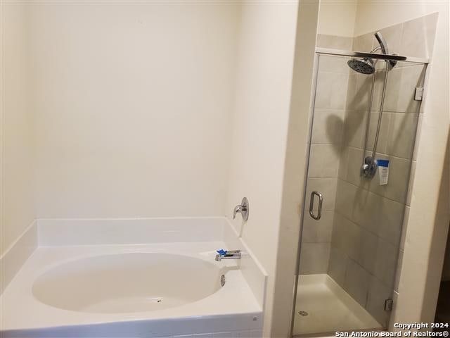 bathroom featuring plus walk in shower