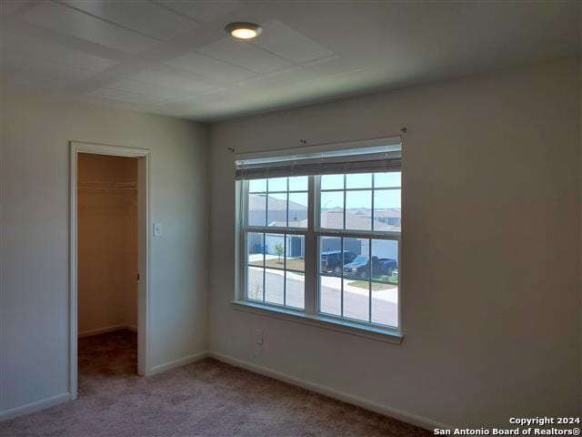 carpeted empty room featuring a mountain view