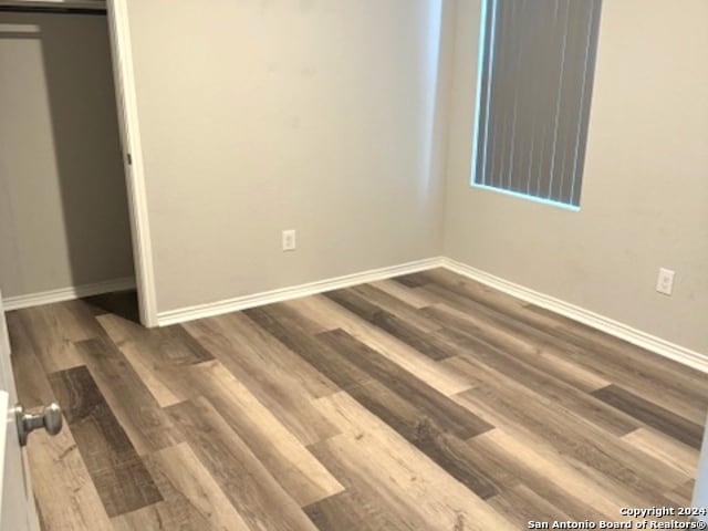 unfurnished room featuring wood-type flooring