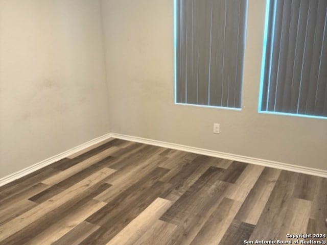 spare room featuring dark wood-type flooring