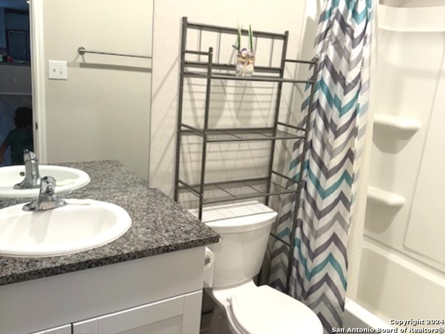 full bathroom with vanity, toilet, and shower / bath combination with curtain