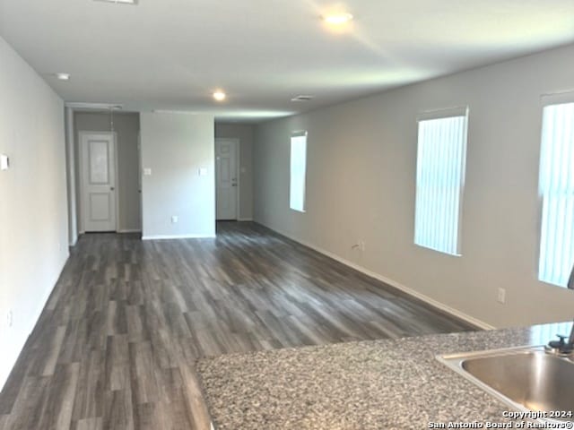 interior space with plenty of natural light and dark hardwood / wood-style flooring