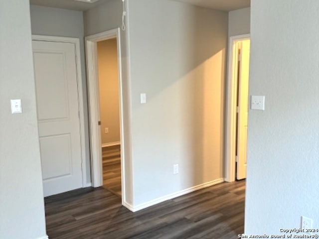 empty room featuring dark wood-type flooring